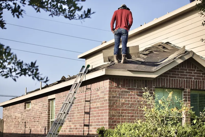 Professional roofer working on a residential roof in Bergheim
